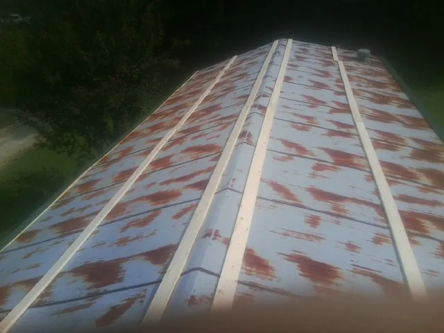 Rusted metal roof panels with new wood purlins before replacement — Storm Damage Roof Repair in Dawson Springs by Roofing Brothers